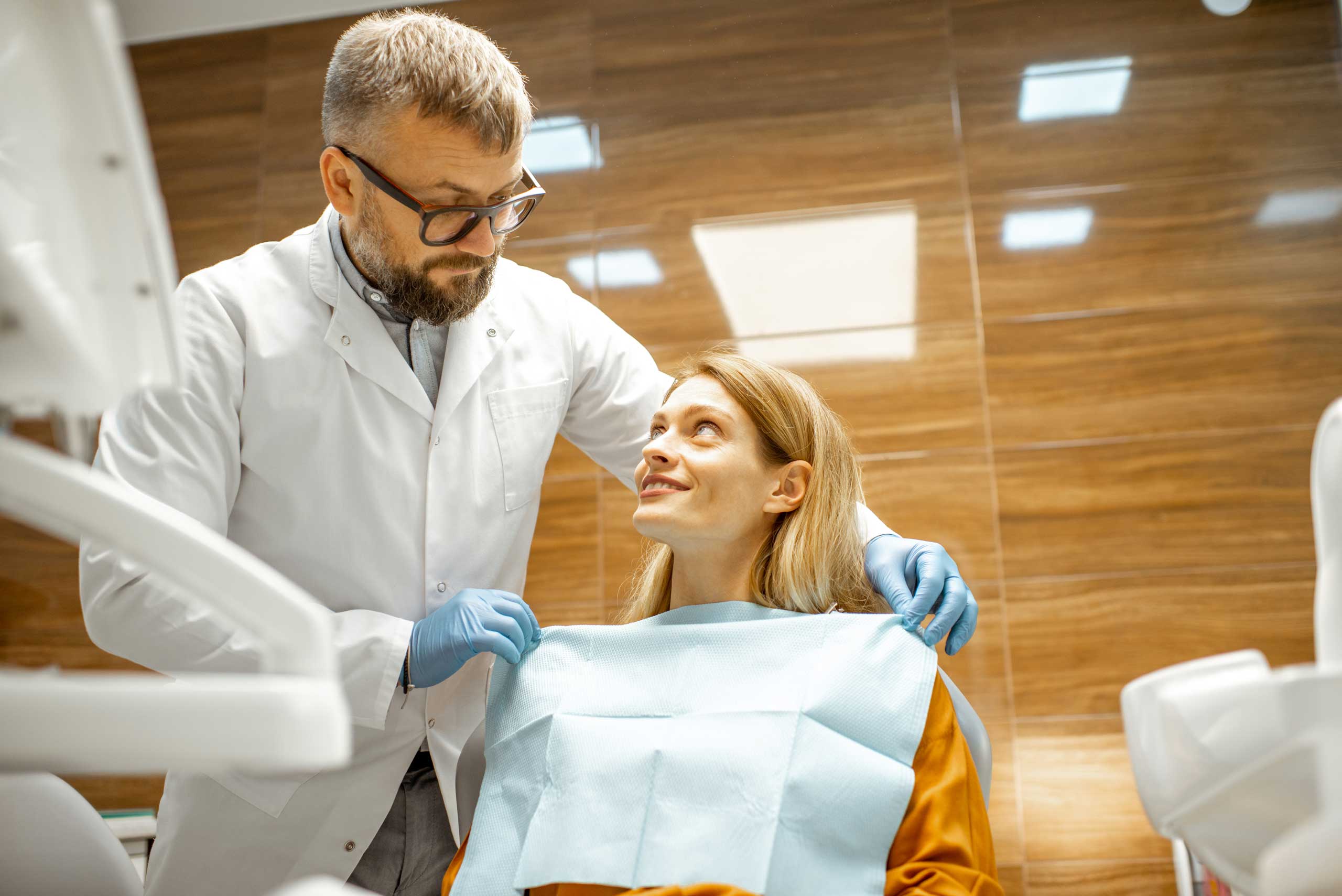Dentist speaking with a patient during a check-up