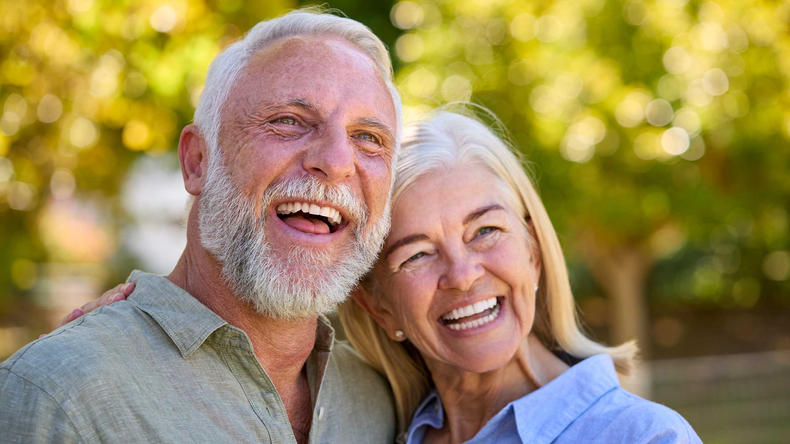Older couple smiling together outdoors