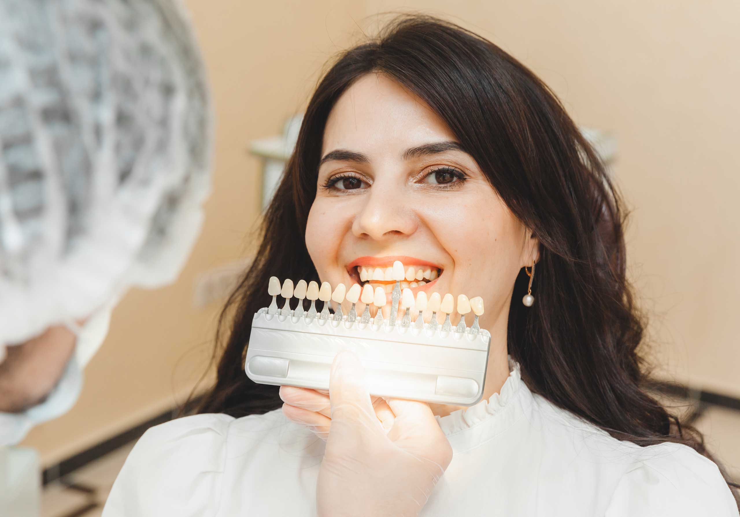 Dental shade guide being compared with natural teeth