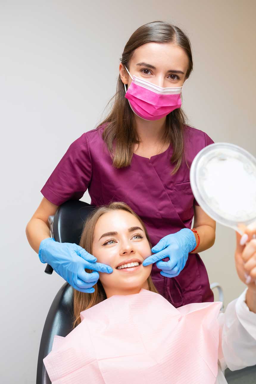 Woman smiling while looking in a mirror